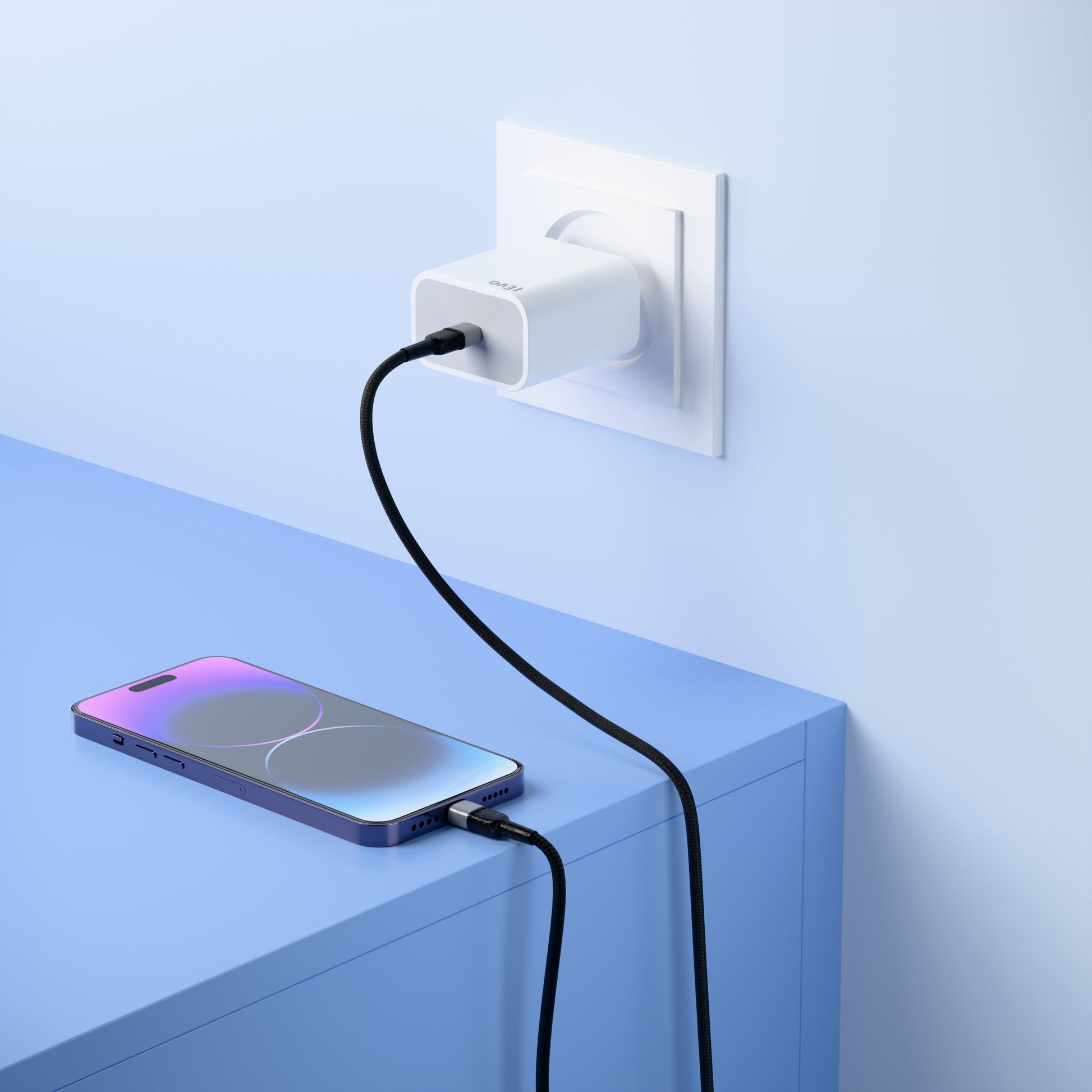 ievonline 20W USB-C mobile charger plugged into wall socket charging a smartphone on blue table